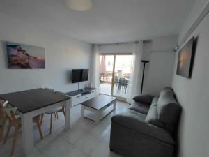 A H Rentals Carles III Apartamento 150mtrs playa في سانت كارليس دي لا رابيتا: غرفة معيشة مع أريكة وطاولة