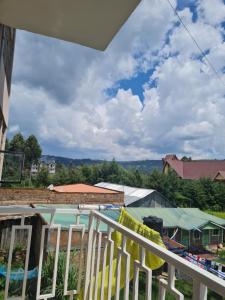 a balcony with a view of a swimming pool at La Ribera Cosy Homes in Bomet