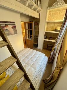 a room with a bed in the middle of a room at Charmante maison dans les remparts in Aigues-Mortes