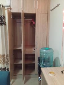 a cupboard in a kitchen with a tank of water at Home Stay 1 in Noida