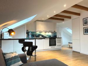 a kitchen with white cabinets and a stove top oven at Stadtherz Lingen in Lingen
