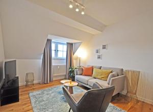 a living room with a couch and a tv at Design-Highlight: Stilvolles Altstadt-Apartment! in Wittlich