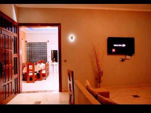 a living room with a tv on the wall at Simba Villa in Arusha