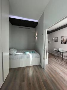 a bedroom with a bed and a table in it at Victory House in Milan
