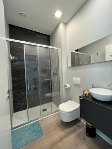 a bathroom with a shower and a toilet and a sink at Victory House in Milan