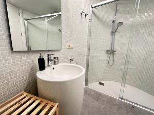 a white bathroom with a sink and a shower at Luxury Downtown C. Del Tratado B in Vigo