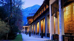 a row of buildings with trees and mountains in the background at Ferienwohnung Sonnendeck mit Bergblick in Bad Reichenhall