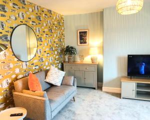 a living room with a couch and a mirror at Harbourmaster Hotel in Aberaeron