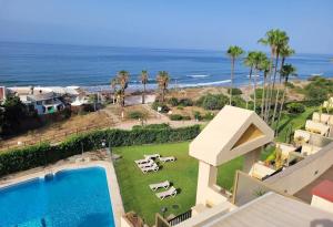 an aerial view of a house with a swimming pool and the ocean at Secret View Elviria in Marbella