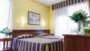 Ripamonti Residence & Hotel Milano tesisinde bir odada yatak veya yataklar