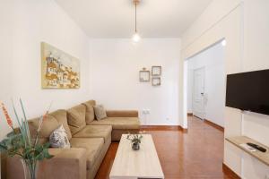 a living room with a couch and a coffee table at Trindade Porto City Centre in Porto