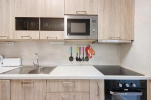 a kitchen with a sink and a microwave at Trindade Porto City Centre in Porto +14 photos