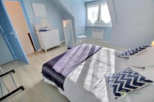 ein Schlafzimmer mit einem Bett, einer Kommode und einem Fenster in der Unterkunft Le ploubaz in Ploubazlanec