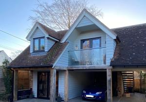 a house with a car parked in the garage at Secluded Island Retreat - in the heart of the Anchorage in West Mersea