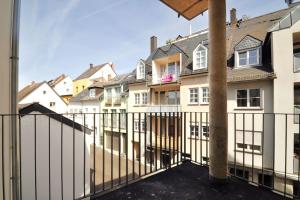 a balcony with a fence and some houses at Modernes Flair: Designer-Apartment in Top-Lage! in Wittlich