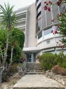 a building with stairs in front of a building at French Riviera apartment with swimming pool and free parking near Monaco in Roquebrune-Cap-Martin