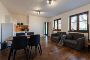 a living room with a table and a couch at PALAVIA Apartments in Pavlov