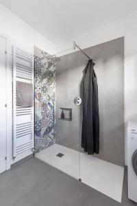 a bathroom with a shower with a glass door at Casa Rina in Cannobio