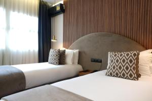 Voodi või voodid majutusasutuse Le M Hôtel toas