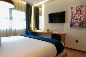 Voodi või voodid majutusasutuse Le M Hôtel toas