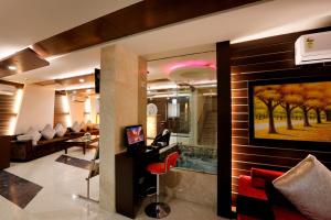 a living room with a large painting on the wall at LA SAPPHIRE HOTEL & RESTUARANT in New Delhi
