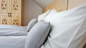 1 dormitorio con cama blanca y almohadas blancas en Forest Inn Berest en Berest