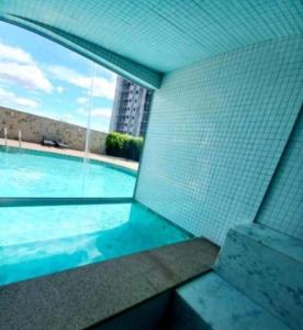 a swimming pool with a view of a building at Moderno e novo apt em frente o shopping Boulevard in Vila Velha