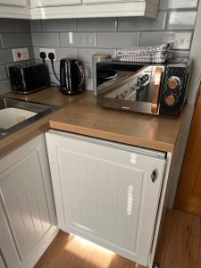 a kitchen with a counter top with a toaster oven at One Bed Rylands Street in Warrington