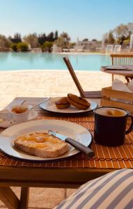 a table with two plates of food and a cup of coffee at Agriturismo Le Site in Corigliano dʼOtranto