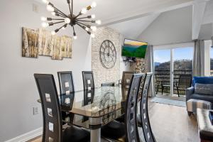 a dining room with a glass table and chairs at Gatlinburg Summit Smoky Mountains View in Gatlinburg