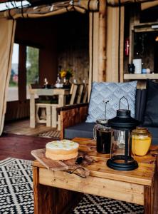 a wooden table with a cake on top of it at Fibden Farm Glamping - Luxury Safari Lodge in Droitwich