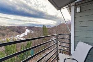 a balcony with a chair and a view of a river at Gatlinburg Summit Smoky Mountains View in Gatlinburg