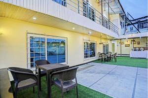 a patio with chairs and a table in a building at Hotel Woods View - Mall Road in Mussoorie