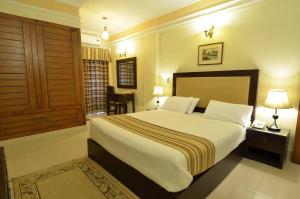 a bedroom with a large bed in a room at Pak Continental Hotel in Bahawalpur