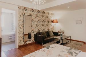 a living room with a couch and a table at Mare Hotel in Dos Hermanas