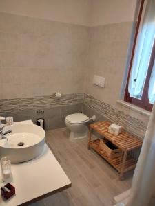 a bathroom with a white toilet and a sink at B&B Le Mi' Cocche in Capannori