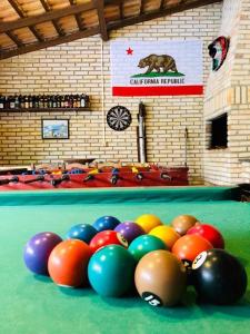 a group of balls on top of a pool table at Sol sal cabana p 10 in Imbituba