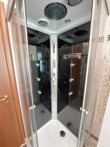 a shower with a glass door in a bathroom at Sunset House Perledo in Perledo +76 photos