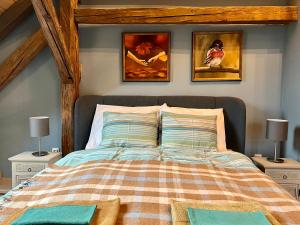 1 dormitorio con 1 cama con 3 cuadros en la pared en Kiss-Henézi Guest House Mád Tokaj, en Mád