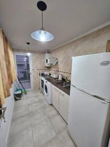 a kitchen with a refrigerator and a washer and dryer at A estrenar a mts de la playa in Mar del Plata