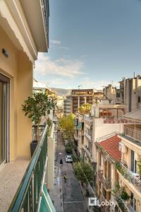a view of a city street from a balcony at Muse Apartment by LobbySquare in Athens
