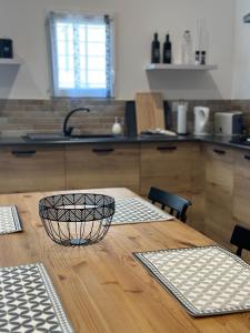 eine Küche mit einem Holztisch mit einer Schüssel darauf in der Unterkunft Maisonnette Du Mas Vert in Montaren-et-Saint-Médiers