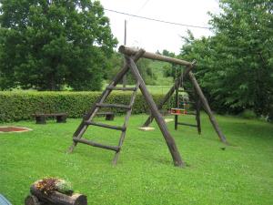an old wooden swing set in a park at Guesthouse Mirko Hodak in Seliste Dreznicko