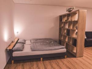 a bedroom with a bed and a book shelf at Ferienwohnung Haßbergliebe in Ebern