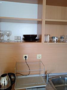 a wire plugged into an outlet in a kitchen at Nessebar, Apartment,South Beach, Larisa, in Nesebar