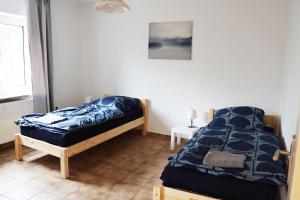 a bedroom with a bed with a blue comforter at Two and three Bedroom Apartments in Remscheid in Remscheid