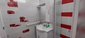 a bathroom with a white toilet and a sink at Monolocale sul Lungomare San Foca in San Foca +17 photos