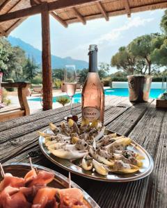 a plate of food and a bottle of wine on a table at Villa Siena in Roquebrune-sur-Argens