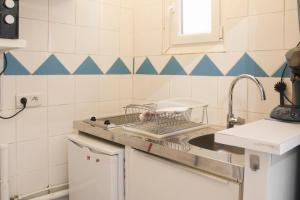 a kitchen with a dish rack on the counter at Bright studio located near Paris in Pantin