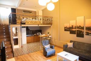 a living room with a couch and a staircase at The Hera Hotels in Istanbul